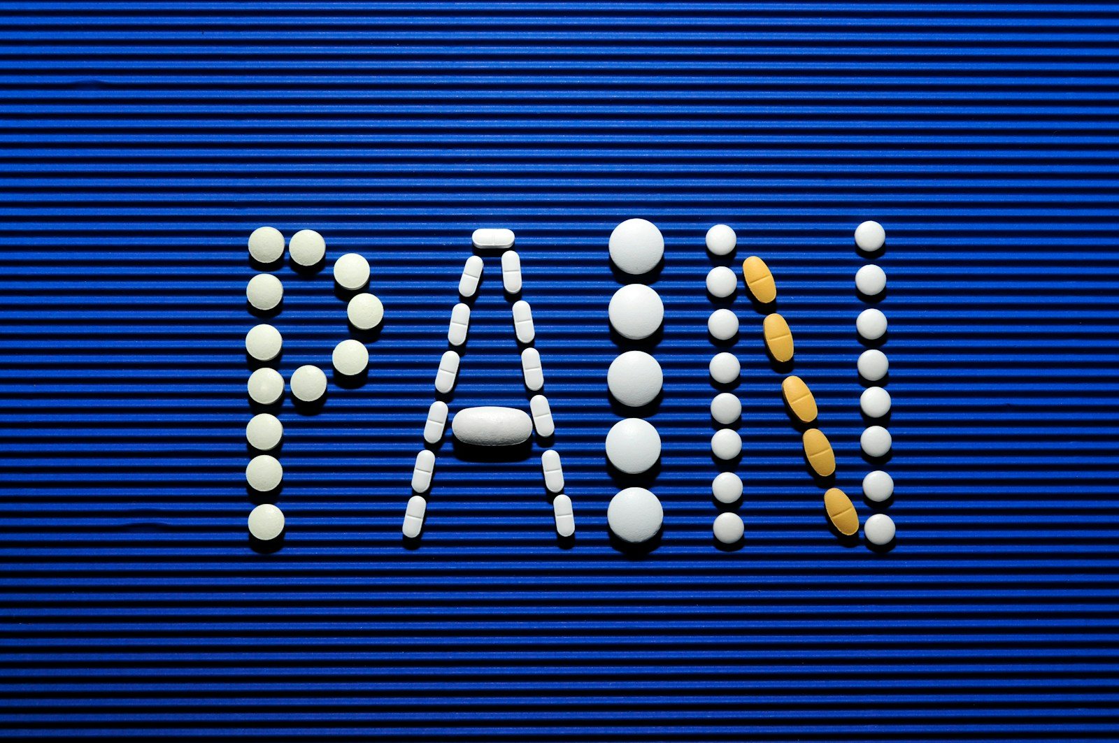 The word war spelled out of pills on a blue background